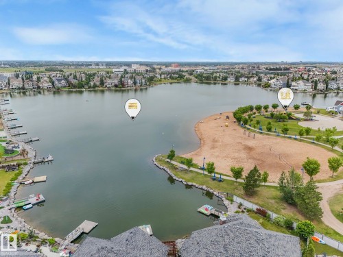 Overhead view of the property's lakefront access, showcasing boat docks, a sandy beach area, and surrounding green spaces - 8112 Summerside Grande Boulevard, Edmonton, AB - Outdoor With Body Of Water With View