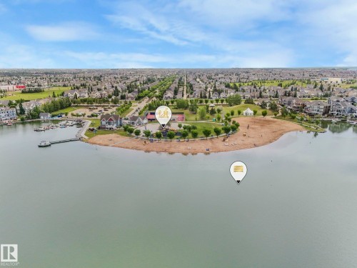 This aerial view showcases a vibrant community with waterfront access - 8112 Summerside Grande Boulevard, Edmonton, AB - Outdoor With Body Of Water With View