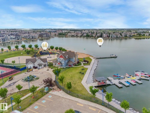 Aerial view of the property with a private dock, lake access, and a tennis court - 8112 Summerside Grande Boulevard, Edmonton, AB - Outdoor With Body Of Water With View