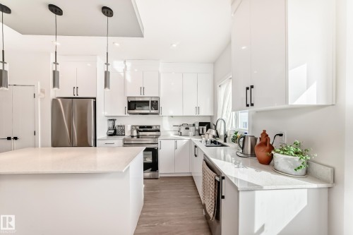 View to the back area with the window above the kitchen sink. - 12435 47 Street Nw, Edmonton, AB - Indoor Photo Showing Kitchen With Upgraded Kitchen