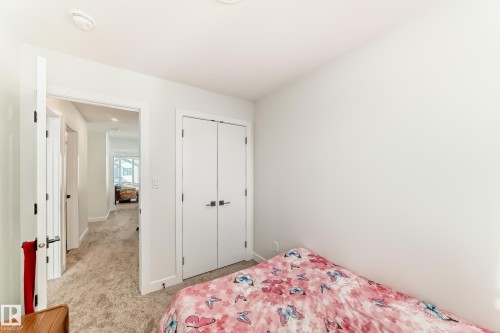 This room features clean white walls and a light-colored carpet - 12435 47 Street Nw, Edmonton, AB - Indoor Photo Showing Bedroom
