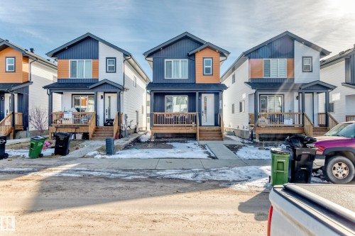 Concrete Side walk from the front of the home to the side entry. Front wood veranda. - 12435 47 Street Nw, Edmonton, AB - Outdoor With Deck Patio Veranda With Facade