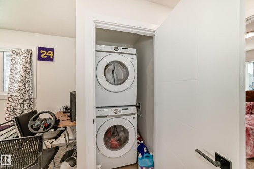 Upstairs Laundry closet. Conveniently located in-unit laundry area with a stacked washer and dryer - 12435 47 Street Nw, Edmonton, AB - Indoor Photo Showing Laundry Room