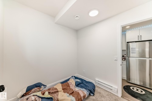 This room features light-colored walls and a carpeted floor - 12435 47 Street Nw, Edmonton, AB - Indoor Photo Showing Bedroom