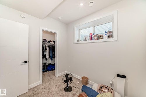 This room features light-colored walls and grey carpet flooring - 12435 47 Street Nw, Edmonton, AB - Indoor Photo Showing Other Room