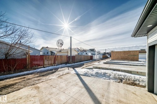 The property features a concrete driveway and side access to the main structure - 12435 47 Street Nw, Edmonton, AB - Outdoor