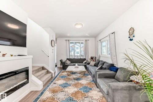 Electric Fireplace to add atmosphere in the LR. - 12435 47 Street Nw, Edmonton, AB - Indoor Photo Showing Living Room With Fireplace