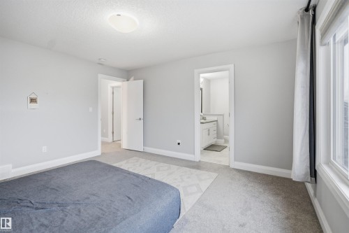This room features light grey walls and light grey carpeting, creating a neutral and inviting atmosphere - 8424 Cushing Court, Edmonton, AB - Indoor Photo Showing Other Room