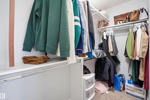 The property features a walk-in closet with white shelving and hanging rods - 8424 Cushing Court, Edmonton, AB - Indoor With Storage