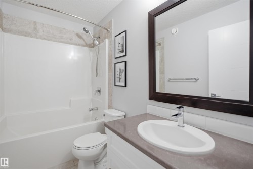Bathroom featuring a white bathtub and shower combination with a tiled surround - 8424 Cushing Court, Edmonton, AB - Indoor Photo Showing Bathroom