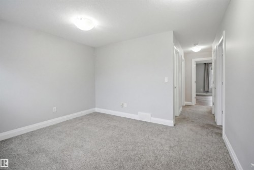 This interior space features light grey walls, grey carpet flooring, and white trim - 8424 Cushing Court, Edmonton, AB - Indoor Photo Showing Other Room