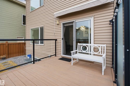 The property features a private deck with a wooden surface and a glass and metal railing, providing an outdoor living space - 8424 Cushing Court, Edmonton, AB - Outdoor With Exterior