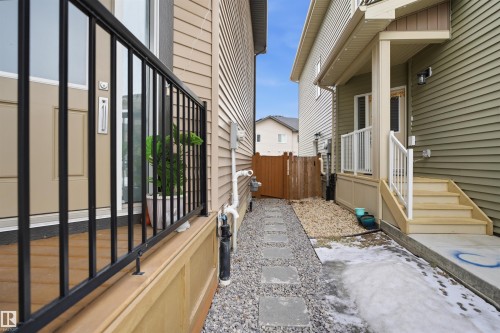 The property features a walkway with stepping stones, a wooden fence, and an exterior with siding - 8424 Cushing Court, Edmonton, AB - Outdoor With Exterior