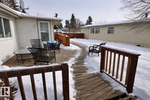 The property features a wood deck with a railing and outdoor seating - 11 Willow Park Estates, Leduc, AB - Outdoor With Deck Patio Veranda With Exterior