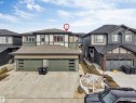 The property features a two-story exterior with a combination of siding and stone accents - 6404 27 Avenue, Edmonton, AB  - Outdoor With Facade 