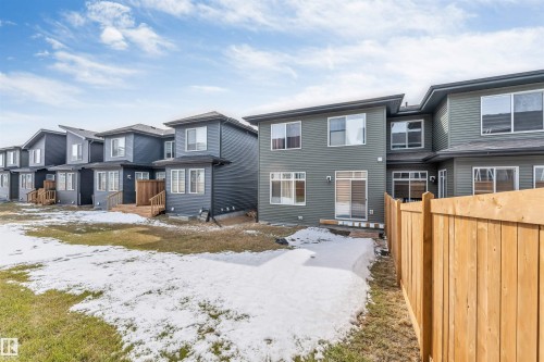 The property features a private backyard with a wooden fence and a sliding glass door providing access to the outdoors - 6404 27 Avenue, Edmonton, AB - Outdoor