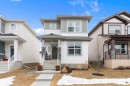 The property features a two-story exterior with white siding and gray accents - 20 Hemingway Crescent, Spruce Grove, AB  - Outdoor With Facade 