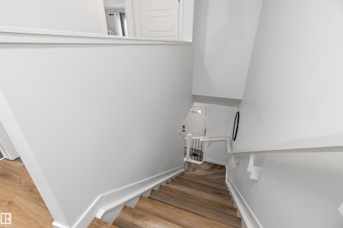 Staircase featuring light-toned wood flooring, white walls, and white handrails - 20 Hemingway Crescent, Spruce Grove, AB - Indoor Photo Showing Other Room