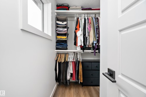 The property features a closet with built-in shelving, hanging rods, and a window - 20 Hemingway Crescent, Spruce Grove, AB - Indoor With Storage