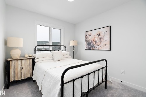 This bedroom features light gray walls, a window with white trim, and gray carpet - 20 Hemingway Crescent, Spruce Grove, AB - Indoor Photo Showing Bedroom