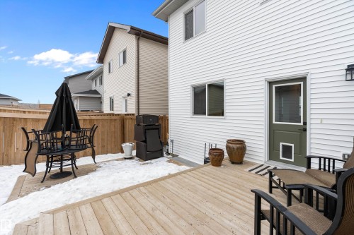The property features a private fenced yard with a wooden deck, providing an ideal outdoor space - 20 Hemingway Crescent, Spruce Grove, AB - Outdoor With Deck Patio Veranda With Exterior