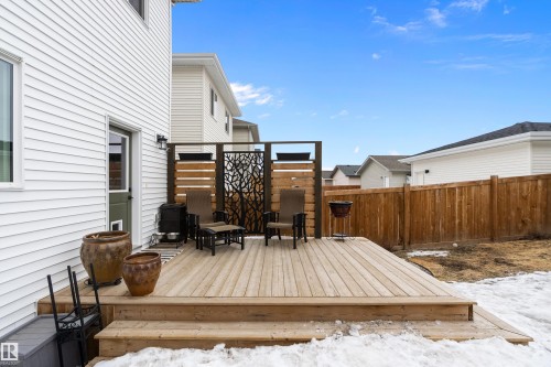 The property features a wooden deck with wooden privacy screens and an exterior door providing direct access - 20 Hemingway Crescent, Spruce Grove, AB - Outdoor With Deck Patio Veranda With Exterior