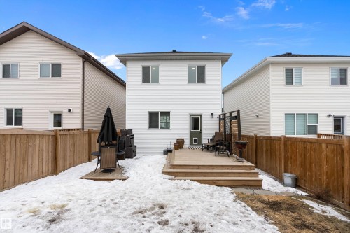 The property features a private backyard with a wooden fence and a multi-level wooden deck - 20 Hemingway Crescent, Spruce Grove, AB - Outdoor With Deck Patio Veranda With Exterior