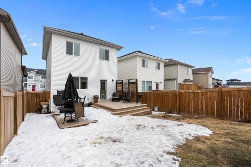The property features a spacious backyard with a wooden fence and a raised deck - 20 Hemingway Crescent, Spruce Grove, AB - Outdoor With Deck Patio Veranda With Exterior