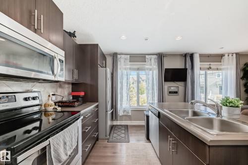 63 3625 144 Avenue Nw, Edmonton, AB - Indoor Photo Showing Kitchen With Stainless Steel Kitchen With Double Sink With Upgraded Kitchen