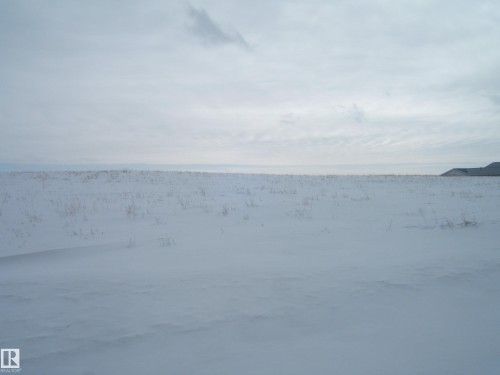 Expansive snow-covered landscape with visible vegetation emerging from the snow - Se 6-55-12 W 4Th, Rural Two Hills County, AB 