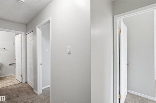 The property features light gray walls and a textured ceiling - 18297 74 Avenue, Edmonton, AB - Indoor Photo Showing Other Room