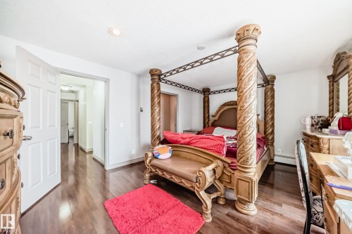 Bedroom with hardwood style flooring and white walls - 12131 101 Street Nw, Edmonton, AB - Indoor Photo Showing Bedroom