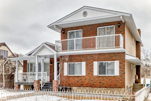 The property features a brick exterior with white trim and a covered front porch - 12131 101 Street Nw, Edmonton, AB - Outdoor