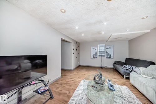 Living area featuring hardwood style flooring, recessed lighting, and light-colored walls - 12131 101 Street Nw, Edmonton, AB - Indoor Photo Showing Living Room
