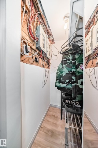 The property includes a utility area with exposed wiring and electrical panels, complemented by light-toned flooring - 12131 101 Street Nw, Edmonton, AB - Indoor Photo Showing Other Room