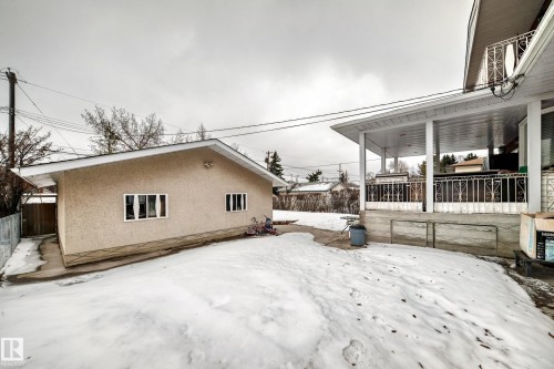 The property includes a detached structure with multiple windows and a covered patio area with decorative railings - 12131 101 Street Nw, Edmonton, AB - Outdoor With Exterior