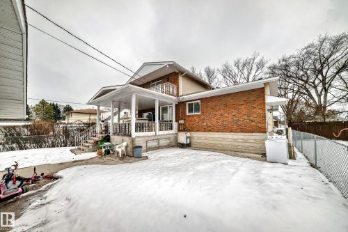 The property features an exterior with brick siding and a covered porch - 12131 101 Street Nw, Edmonton, AB - Outdoor