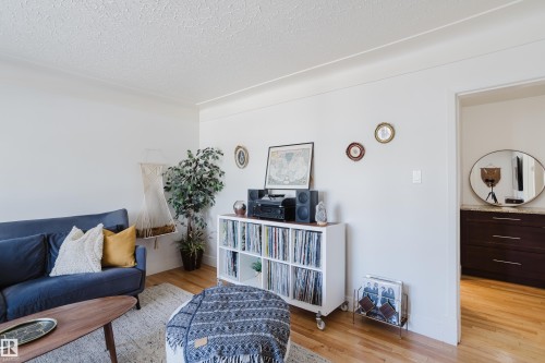 This living area features light hardwood flooring and white walls, creating a bright and airy atmosphere - 10643 66 Avenue, Edmonton, AB - Indoor Photo Showing Living Room
