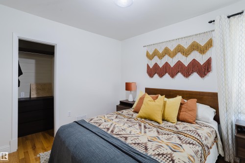 This bedroom features light-colored walls and hardwood flooring - 10643 66 Avenue, Edmonton, AB - Indoor Photo Showing Bedroom