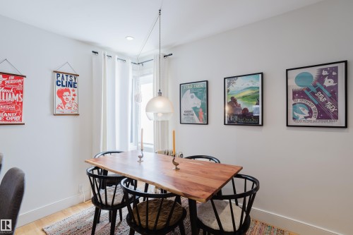 Dining area featuring light hardwood flooring and a contemporary pendant light fixture - 10643 66 Avenue, Edmonton, AB - Indoor Photo Showing Dining Room