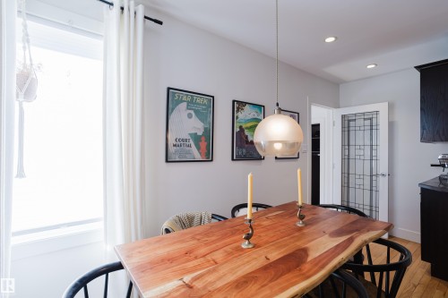 Dining area featuring a natural wood table, recessed lighting, and a decorative pendant light fixture - 10643 66 Avenue, Edmonton, AB - Indoor