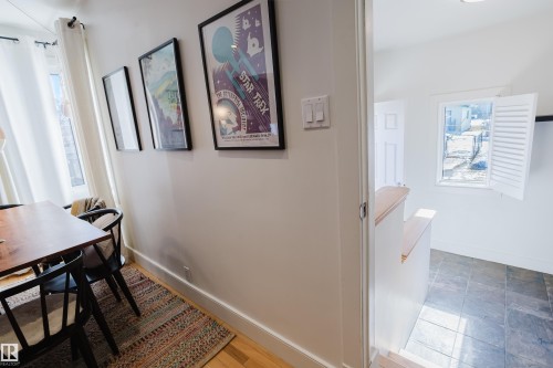 The property features hardwood floors in the foreground and tiled flooring in the background, with white walls throughout - 10643 66 Avenue, Edmonton, AB - Indoor