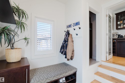 Entryway featuring white walls, a built-in window with white shutters, and a storage bench with an upholstered top - 10643 66 Avenue, Edmonton, AB - Indoor Photo Showing Other Room
