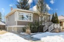 The property features a charming exterior with neutral-toned siding, a bay window, and a welcoming front porch with white railings - 10643 66 Avenue, Edmonton, AB  - Outdoor 