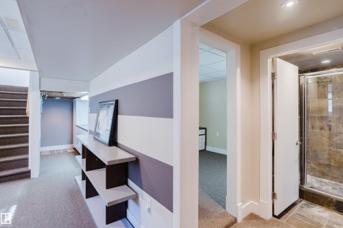 The property features a staircase with carpeted steps and a hallway with neutral carpeting - 10643 66 Avenue, Edmonton, AB - Indoor Photo Showing Other Room