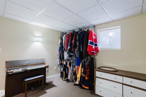 Room featuring light beige walls, a drop ceiling, and carpeted flooring - 10643 66 Avenue, Edmonton, AB - Indoor