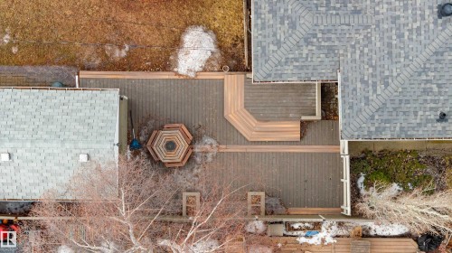 Expansive outdoor deck with a hexagonal fire pit feature - 10643 66 Avenue, Edmonton, AB - 