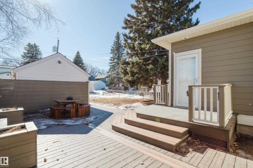 The property features a private deck with stairs, a white screen door, and a partially fenced yard - 10643 66 Avenue, Edmonton, AB - Outdoor With Deck Patio Veranda With Exterior