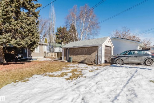 The property features a detached garage with a white garage door and siding - 10643 66 Avenue, Edmonton, AB - Outdoor
