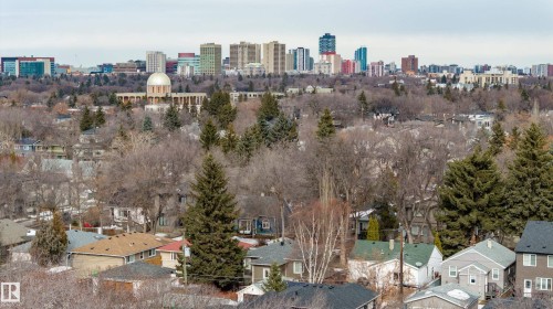 This property offers panoramic views of the surrounding neighborhood, featuring a mix of residential rooftops and mature trees - 10643 66 Avenue, Edmonton, AB - Outdoor With View